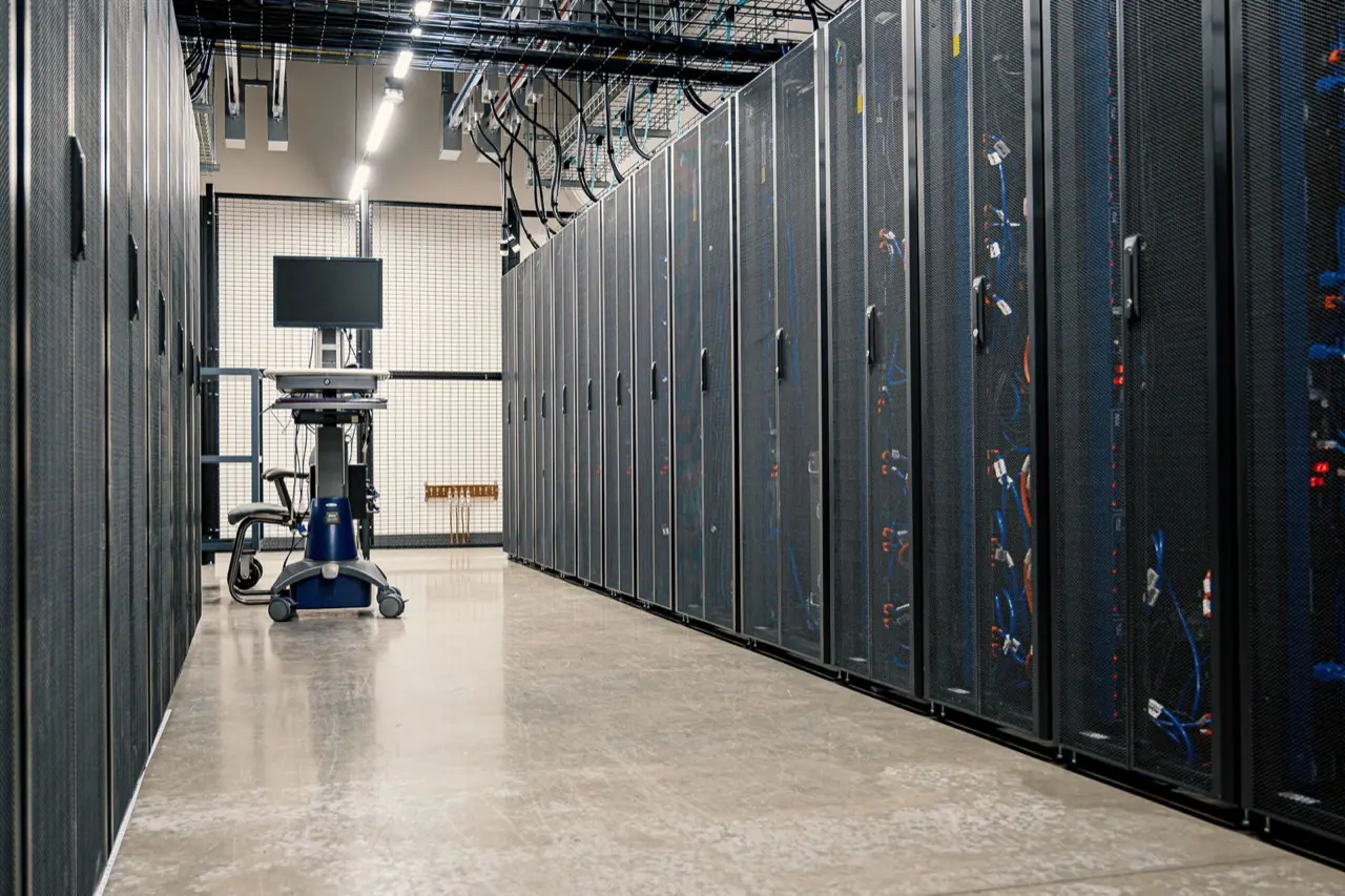 Rows of server racks with network cabling in a data room